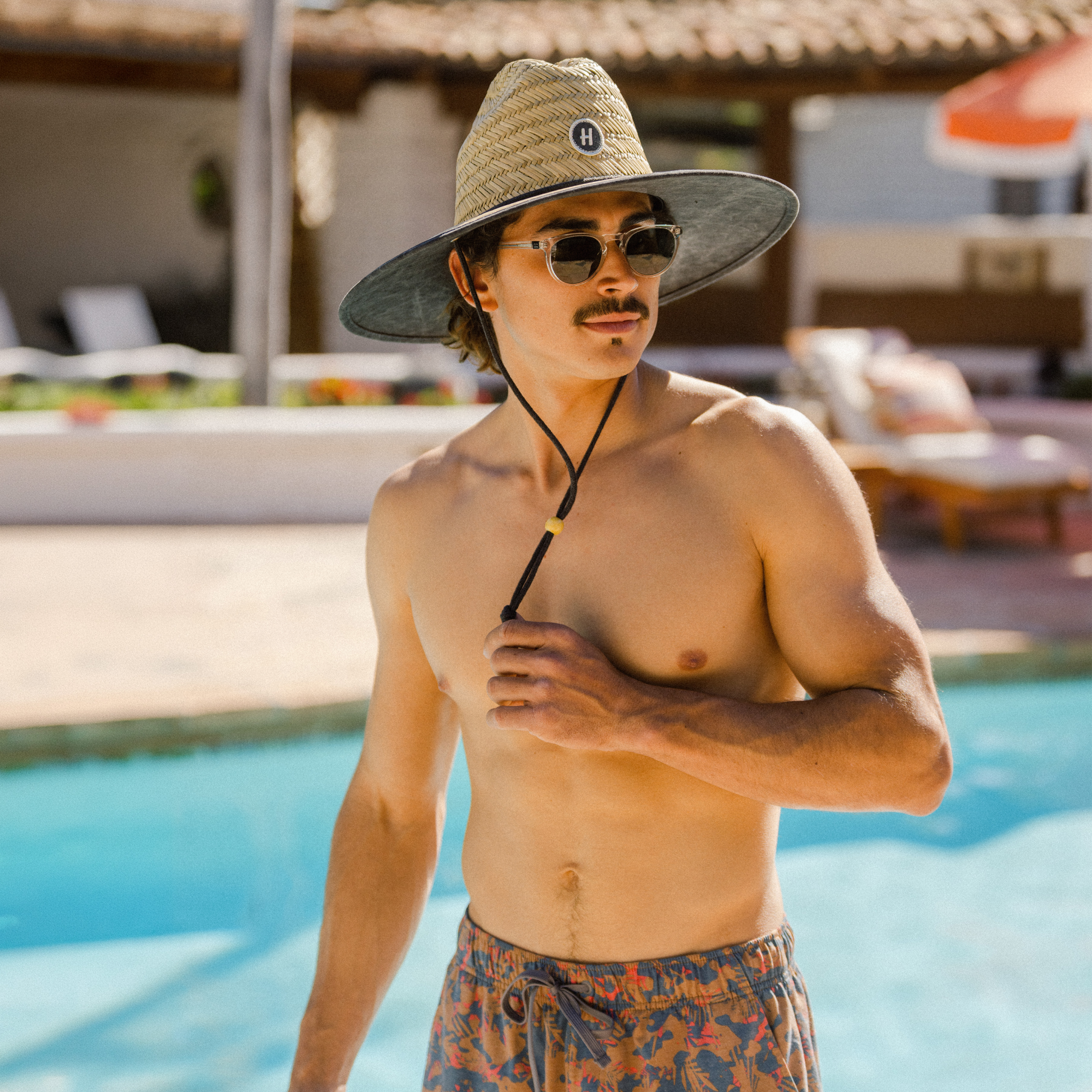 hemlock male model wearing the solid black lifeguard straw hat - xl styles