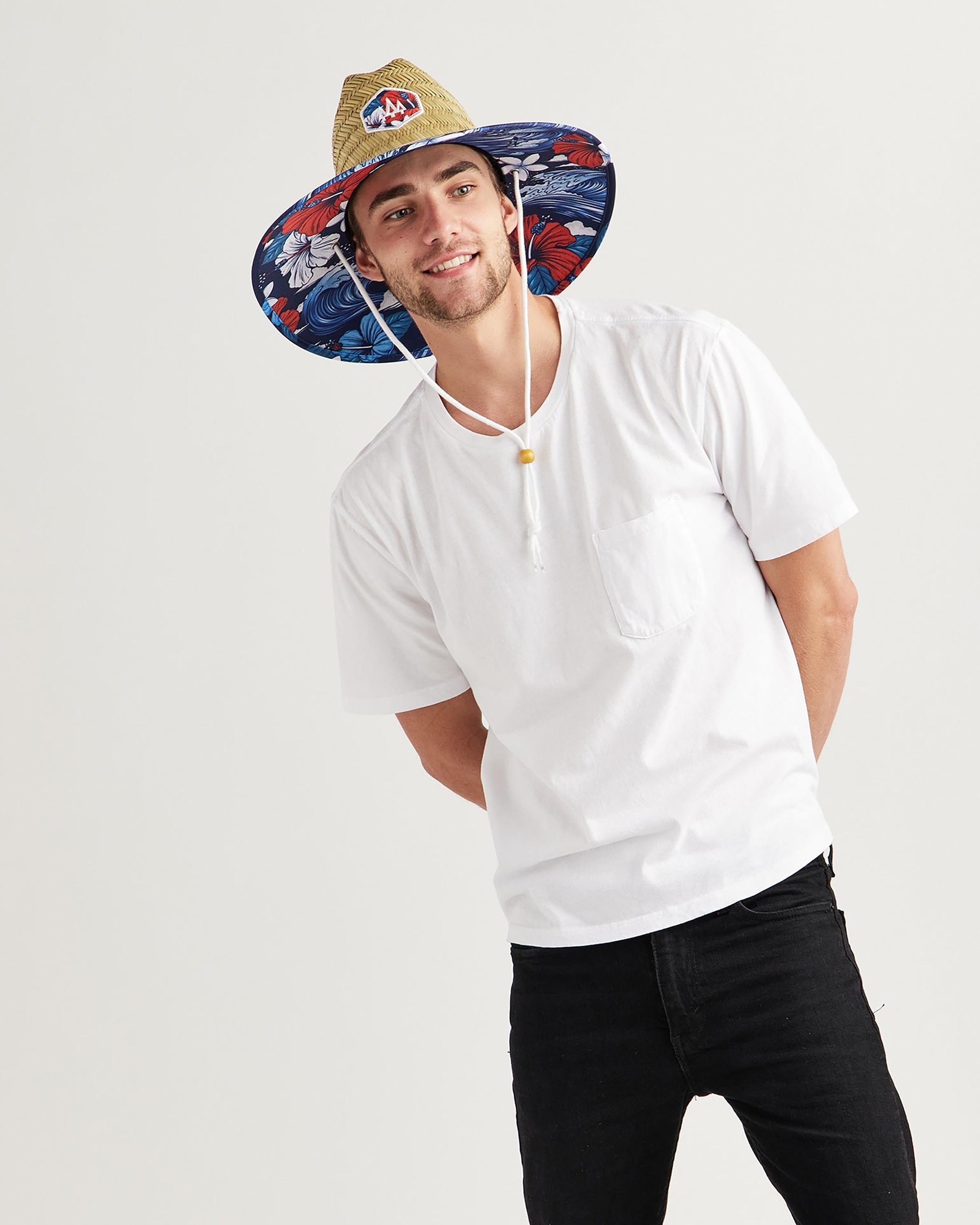 Hemlock male model leaning to the side wearing Midway straw lifeguard hat with USA floral pattern