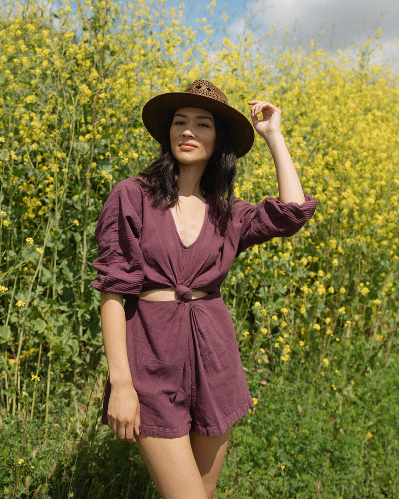 Hemlock female model looking straight wearing Miller Straw Hat in Mocha