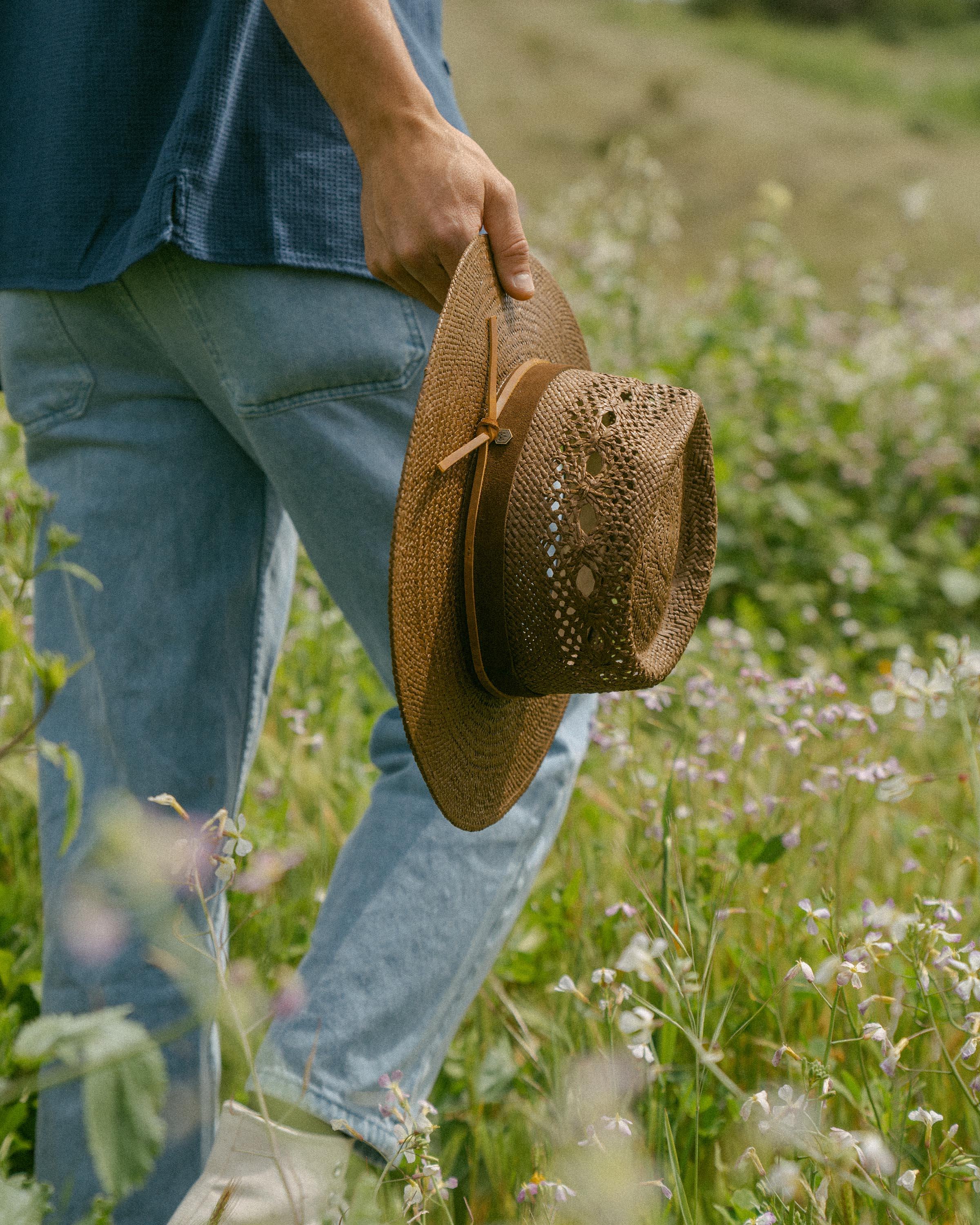 Hemlock male model holding Miller Straw Hat in Mocha