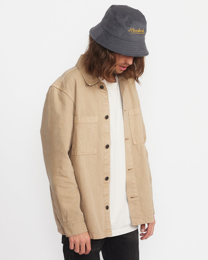 Hemlock male model looking down wearing Newport Corduroy Bucket Hat in Dusty Blue