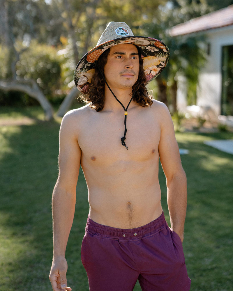 Hemlock male model looking right wearing Nightcap straw lifeguard hat with pineapple pattern