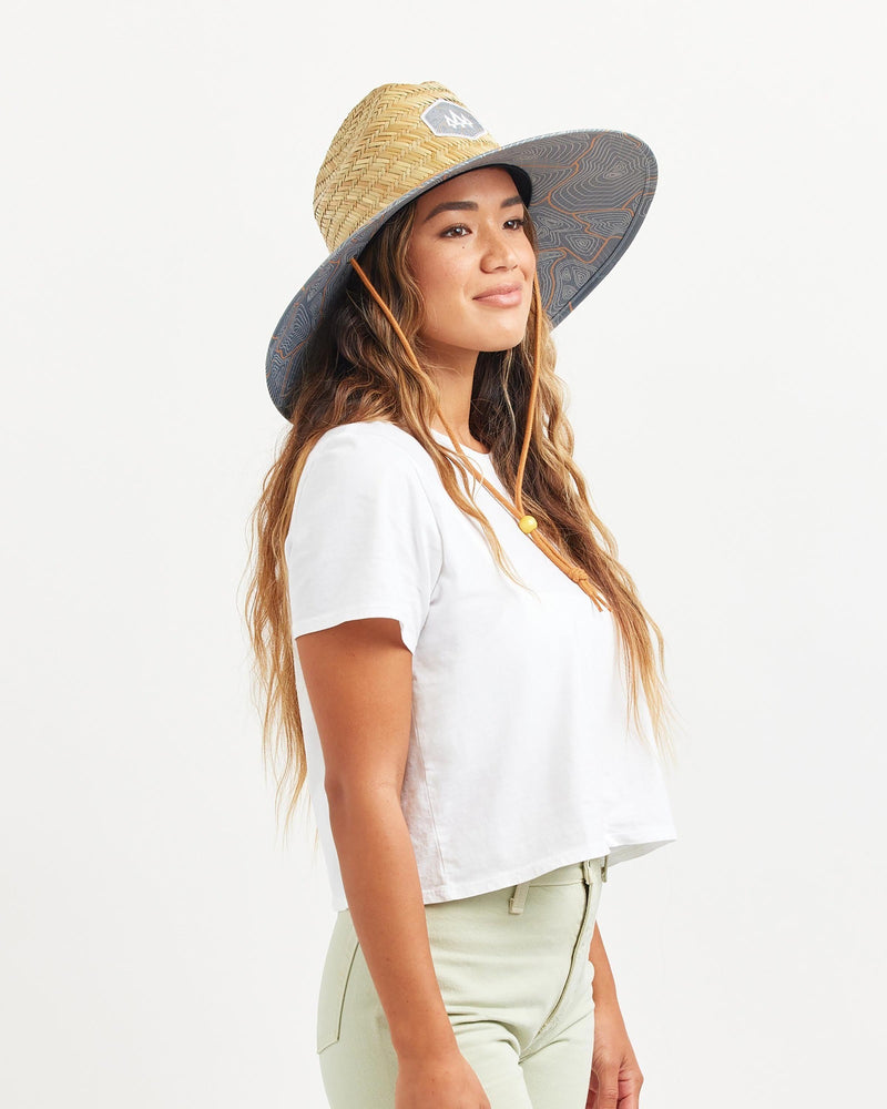 Hemlock female model looking right wearing Nomad straw lifeguard hat with topography pattern
