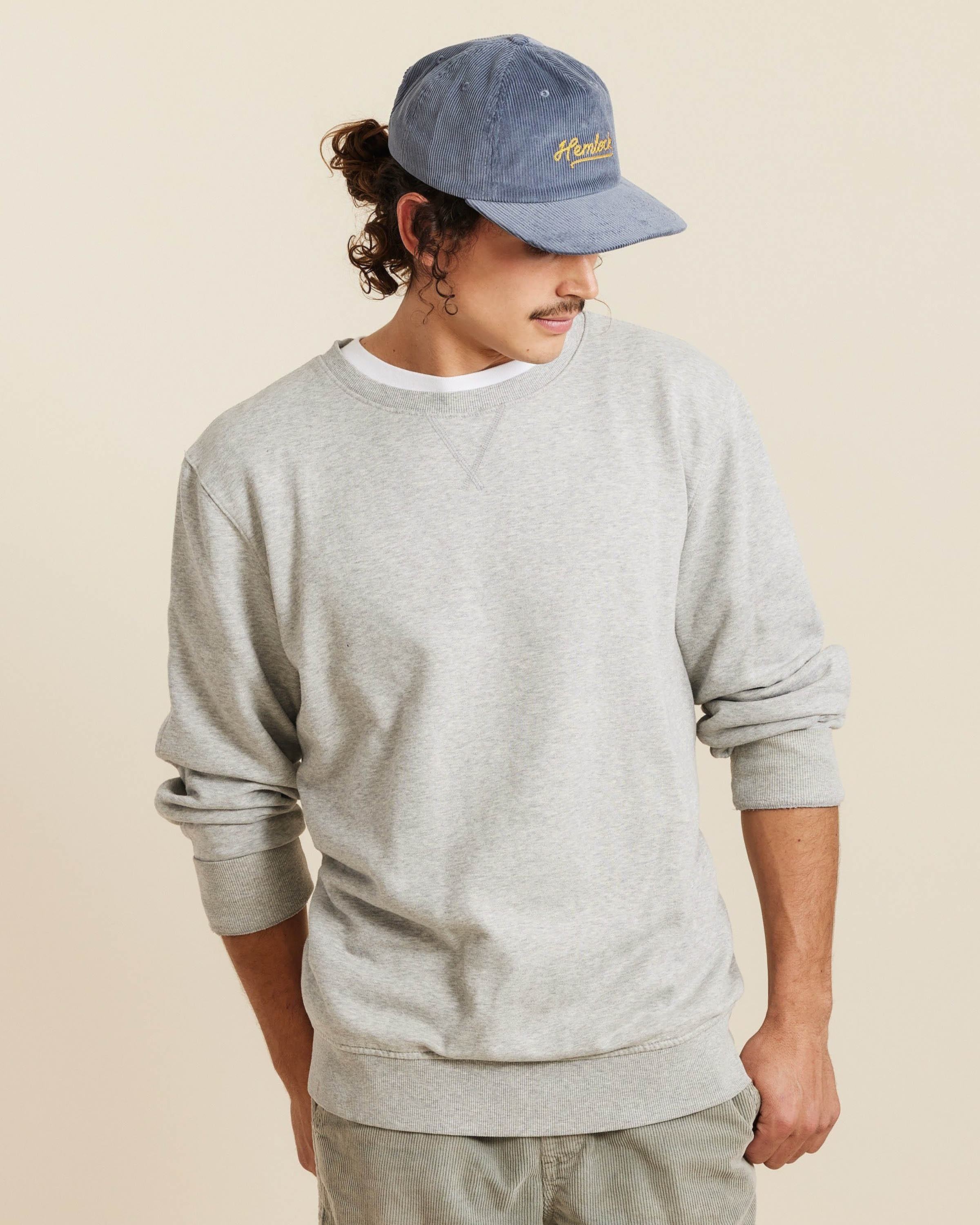 Hemlock male model looking down wearing Hemlock Wesley Corduroy Baseball Hat in Dusty Blue