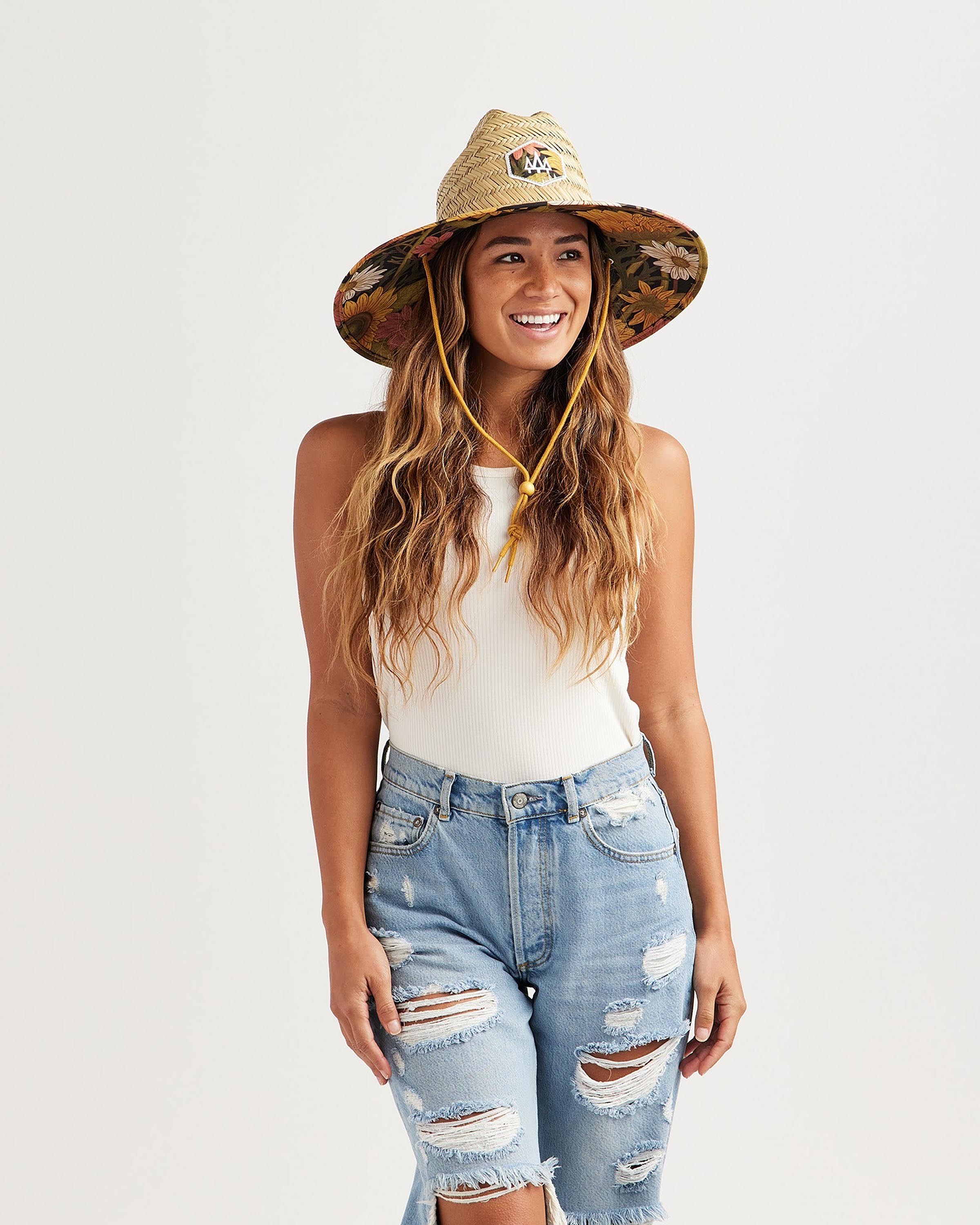 Hemlock female model looking right wearing Woodstock straw lifeguard hat with sunflower pattern