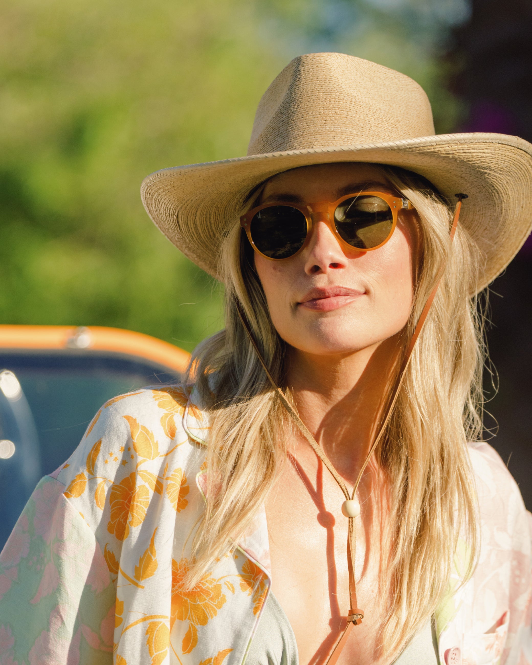 Hemlock female model wearing the Bruma Cowboy Fedora Straw Hat on a sunny day
