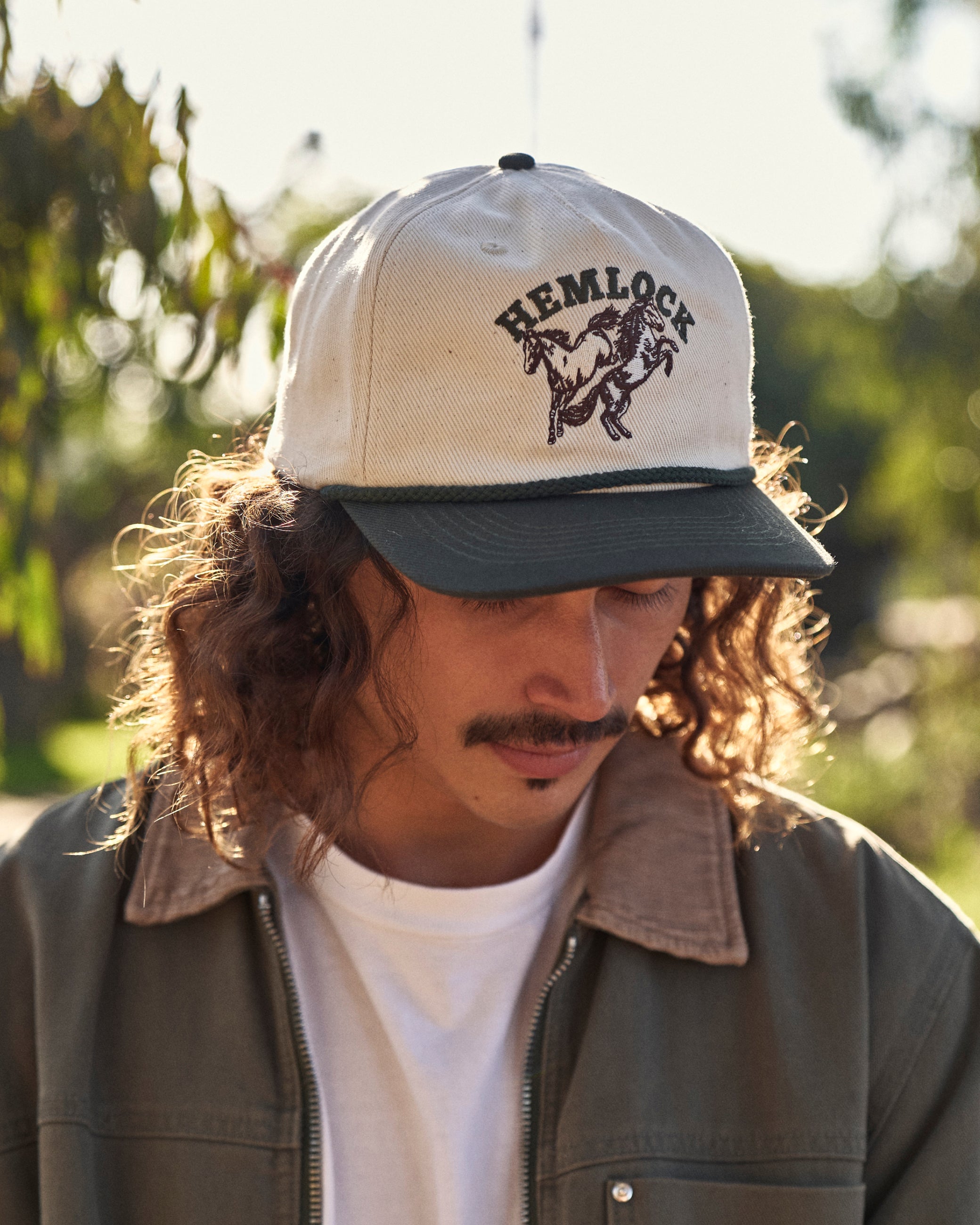Hemlock male model wearing the Buckin Baseball Hat Green close up
