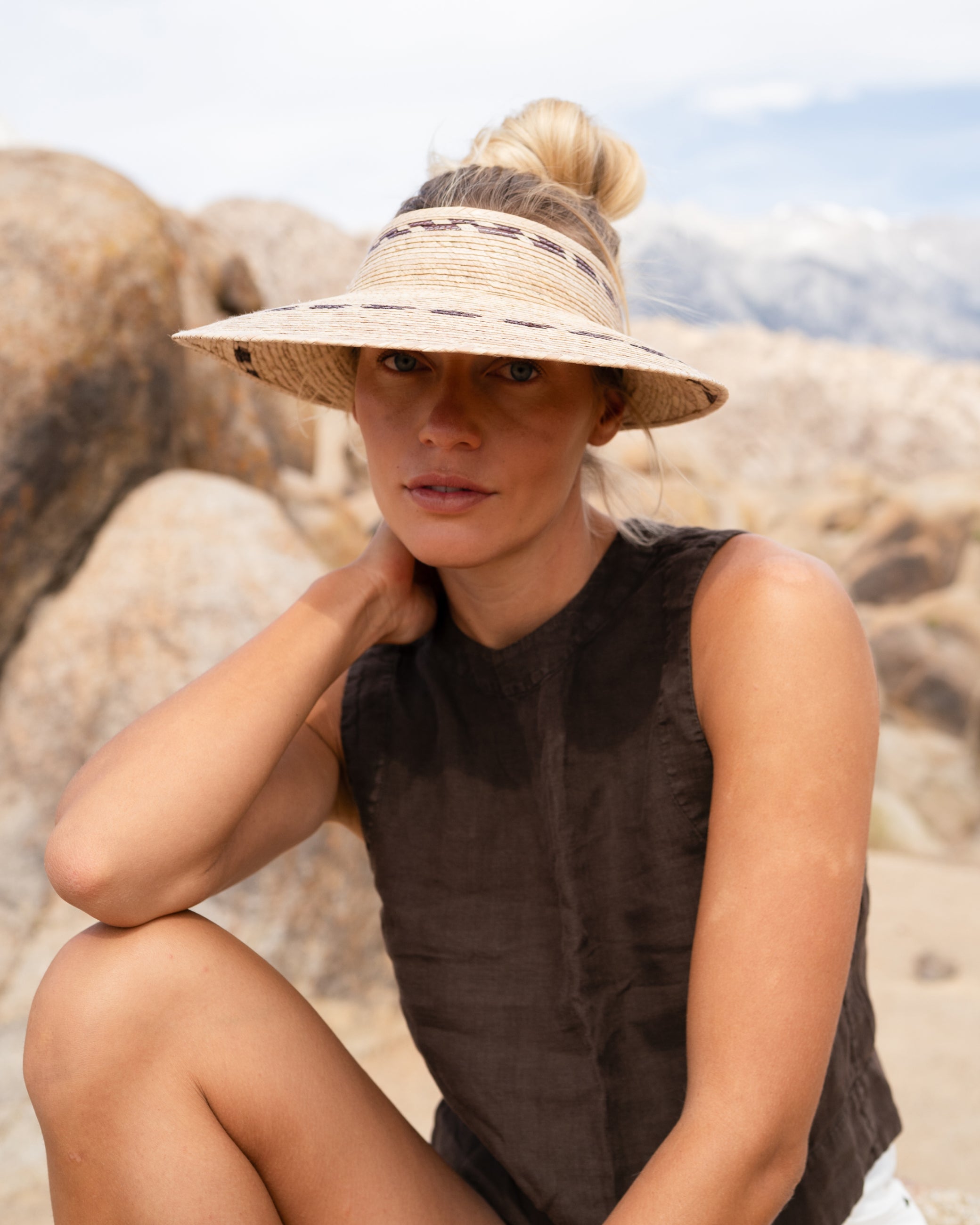 Hemlock female model wearing the Catalina Straw Visor on a hike 