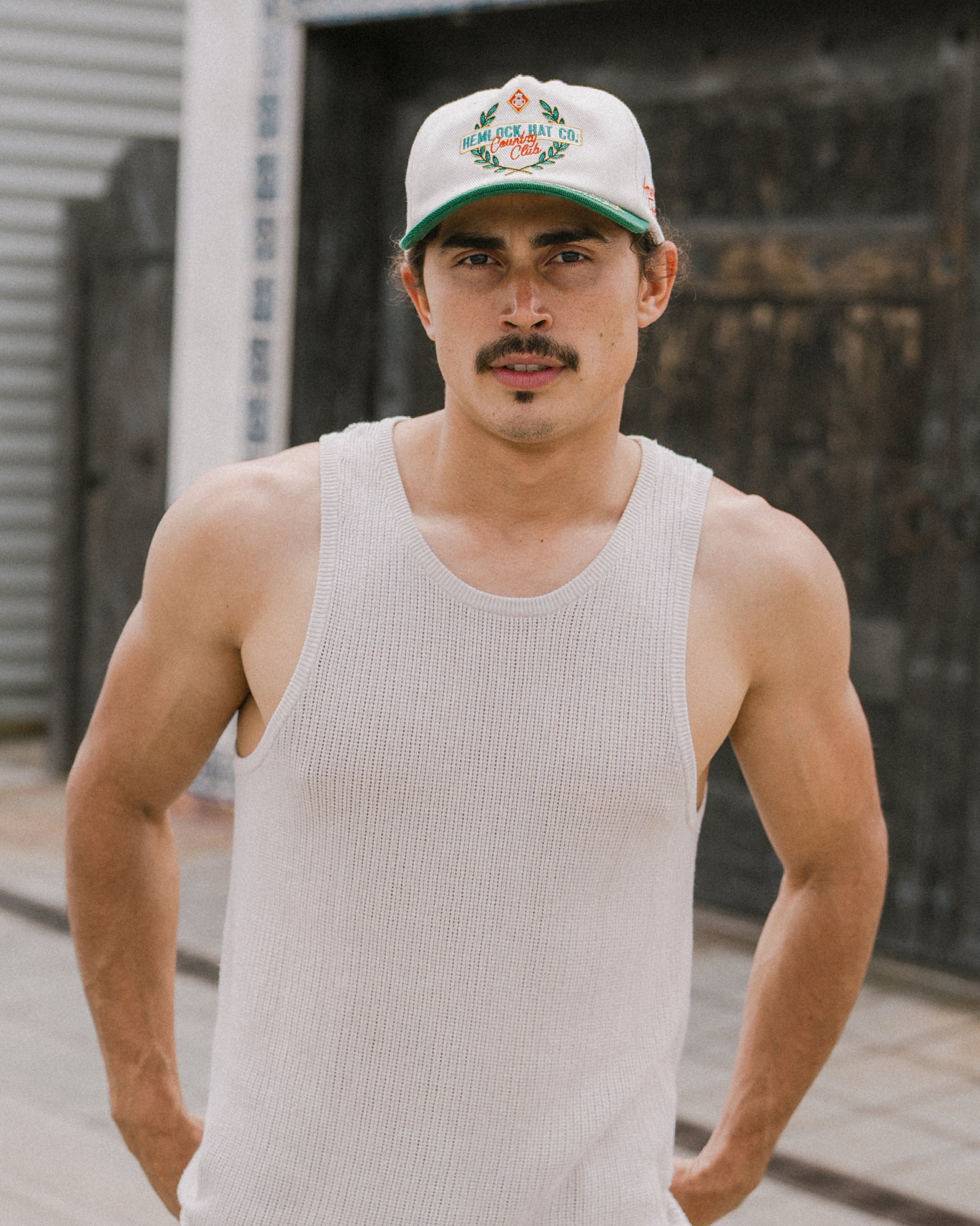 Hemlock male model wearing the Fairway baseball hat in emerald