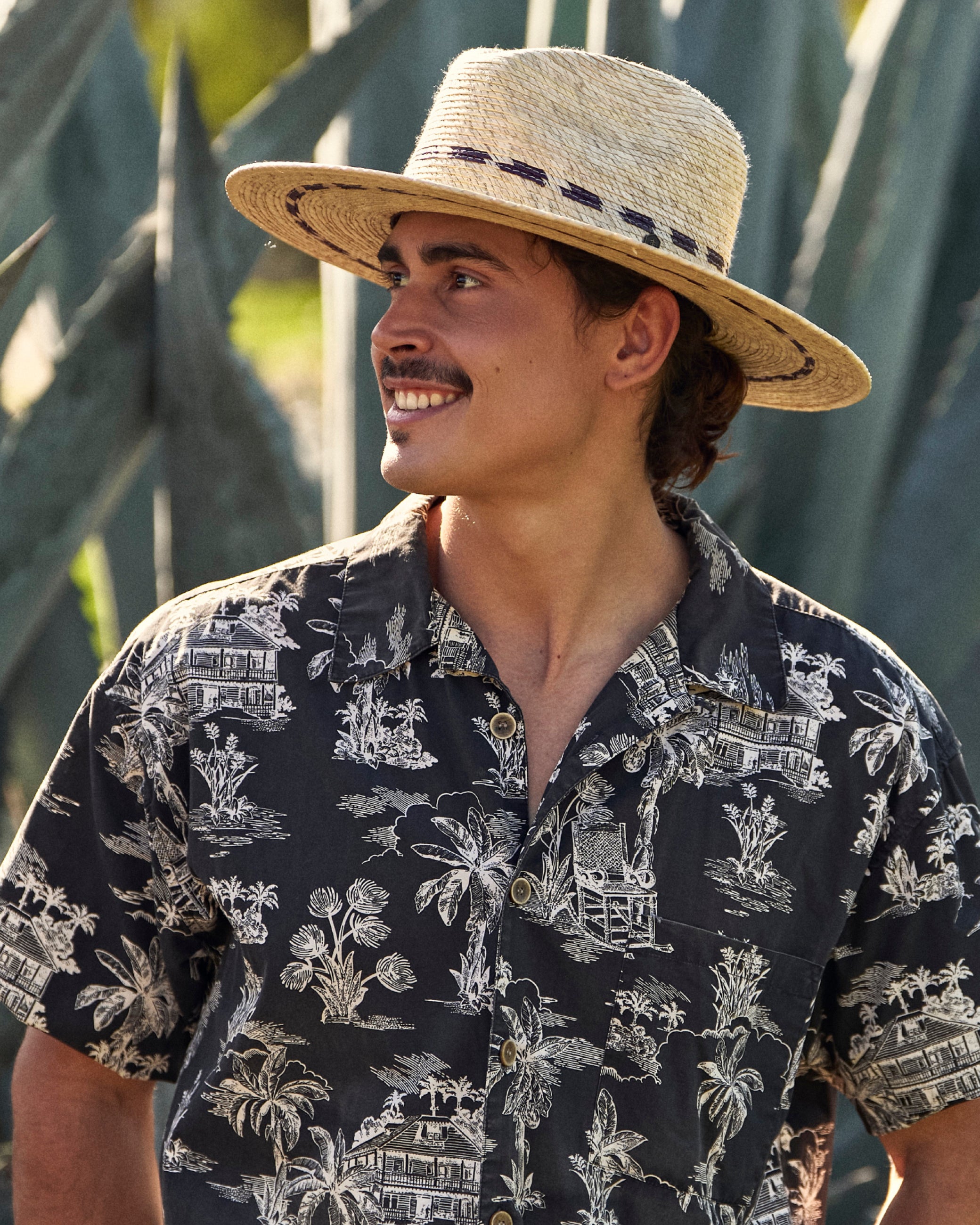 Hemlock male model wearing the Hermosa Fedora Straw Hat looking to the side