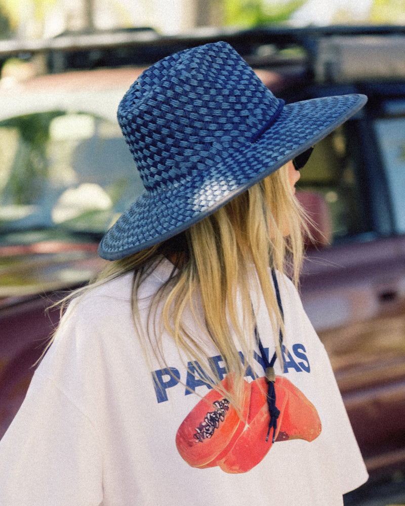 Hemlock female model wearing the Lana Paper Straw Lifeguard Hat looking away