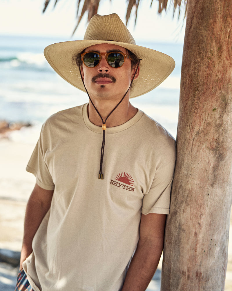 Hemlock male model wearing the Las Olas packable lifeguard in white sand at the beach
