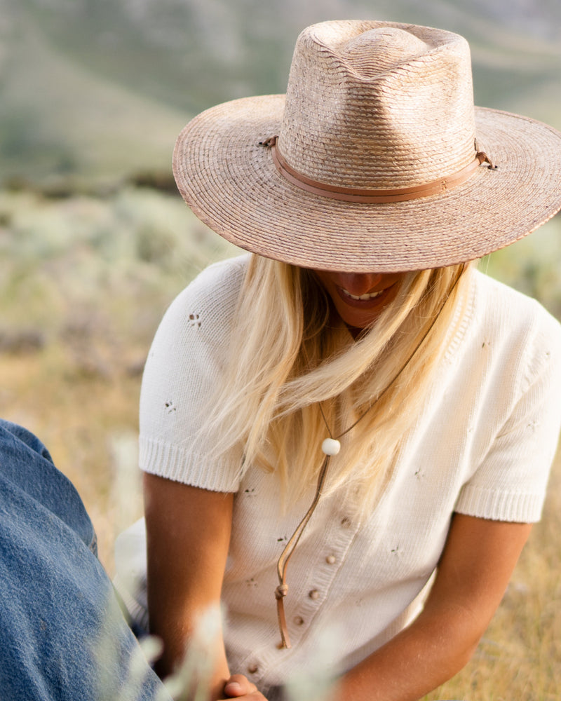 female model wearing the Hemlock Morro Fedora Straw Hat in color Toast close up