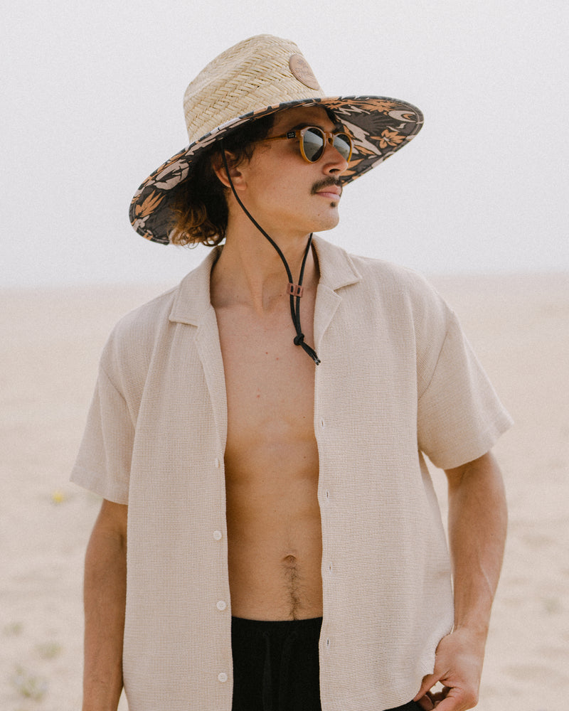 Hemlock male model wearing the UPF 50+ Lifeguard in Desert Bloom at the beach