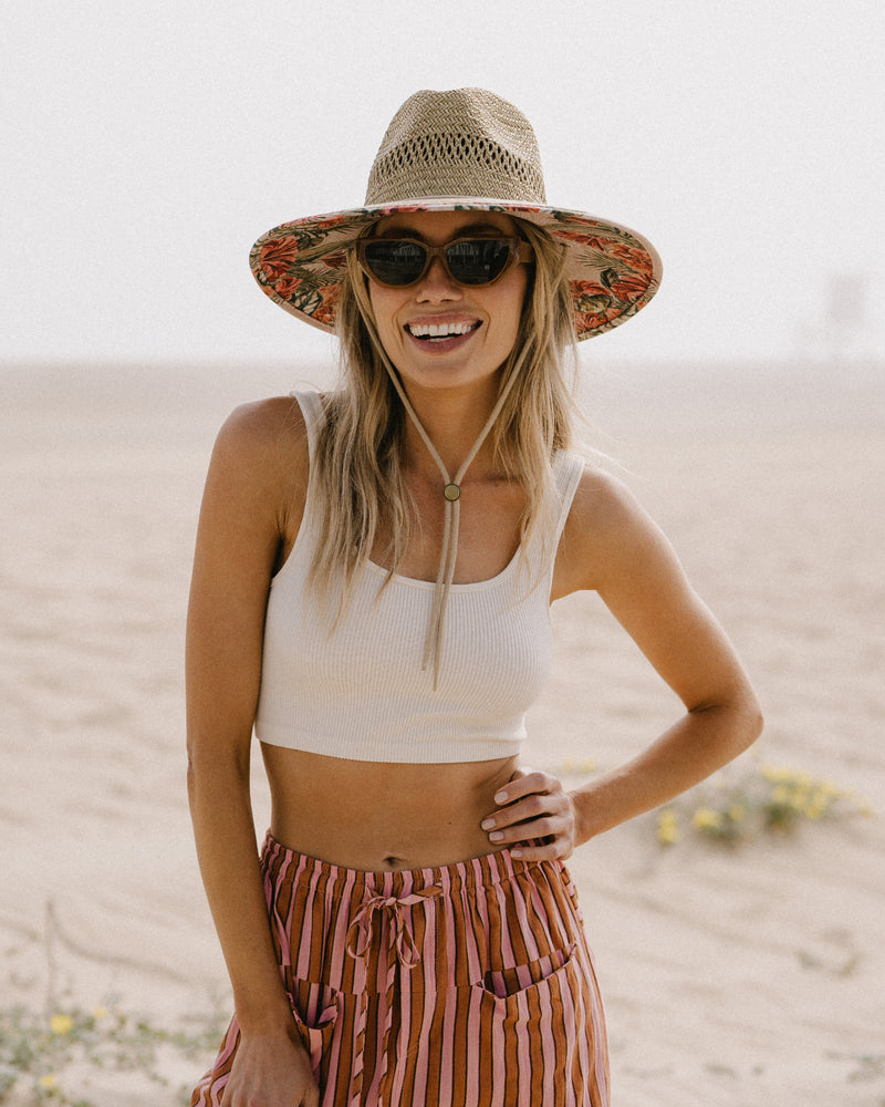 Hemlock female model wearing the UPF50+ Lifeguard hat in Hibiscus print